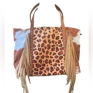 Oversized shoulder bag animal print on front fringe on front zipper closure